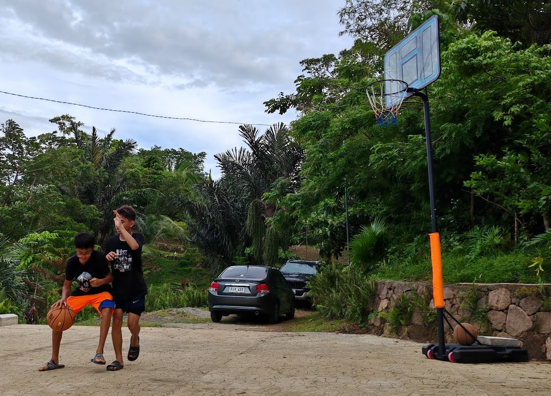 Half-court basketball on the farm grounds