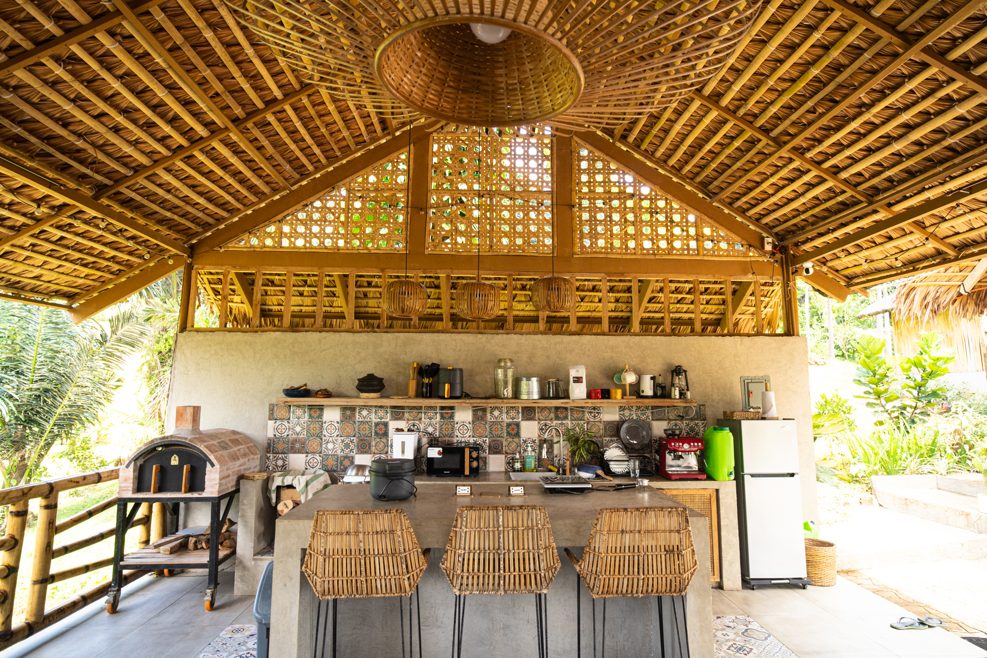 Outdoor kitchen surrounded by lush greenery
